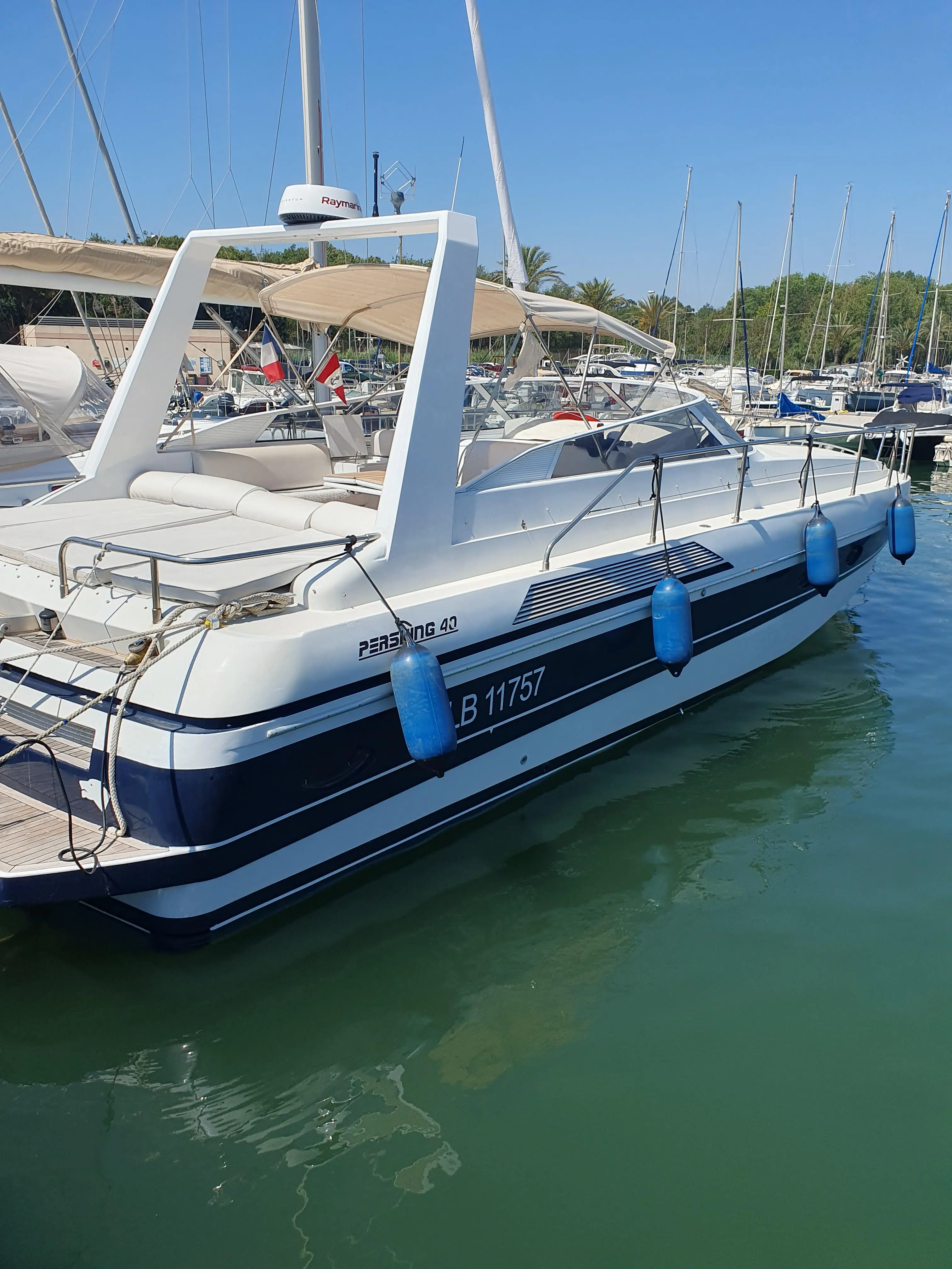 Pershing 40 — Bateau à moteur amarré dans un port, photographié de trois quarts arrière.