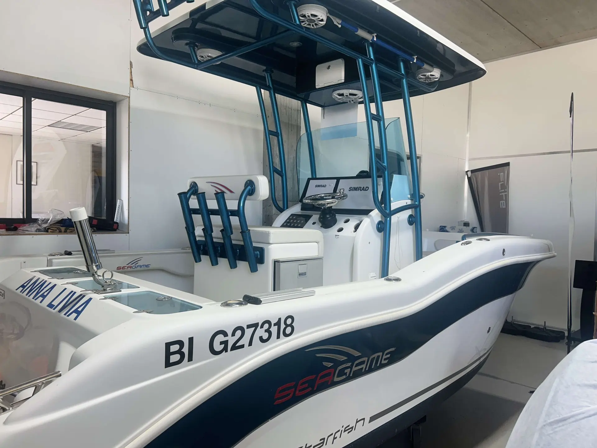 Seagame Starfish 200 — Bateau semi-rigide présenté en intérieur, avec console de pilotage et arceau.