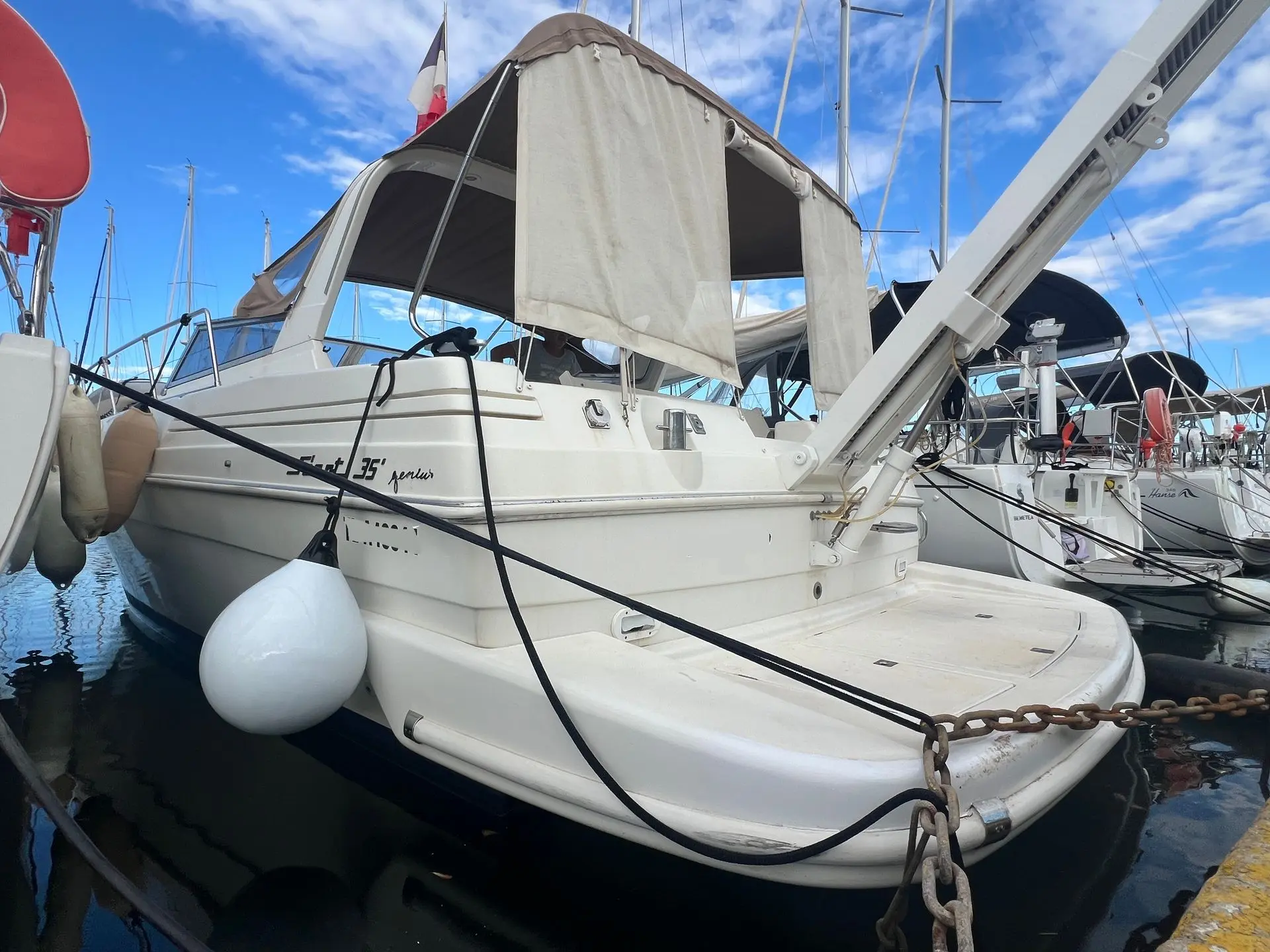 Fiart Mare Fiart 35 Genius — Bateau à moteur blanc amarré, vu de trois quarts arrière dans un port.