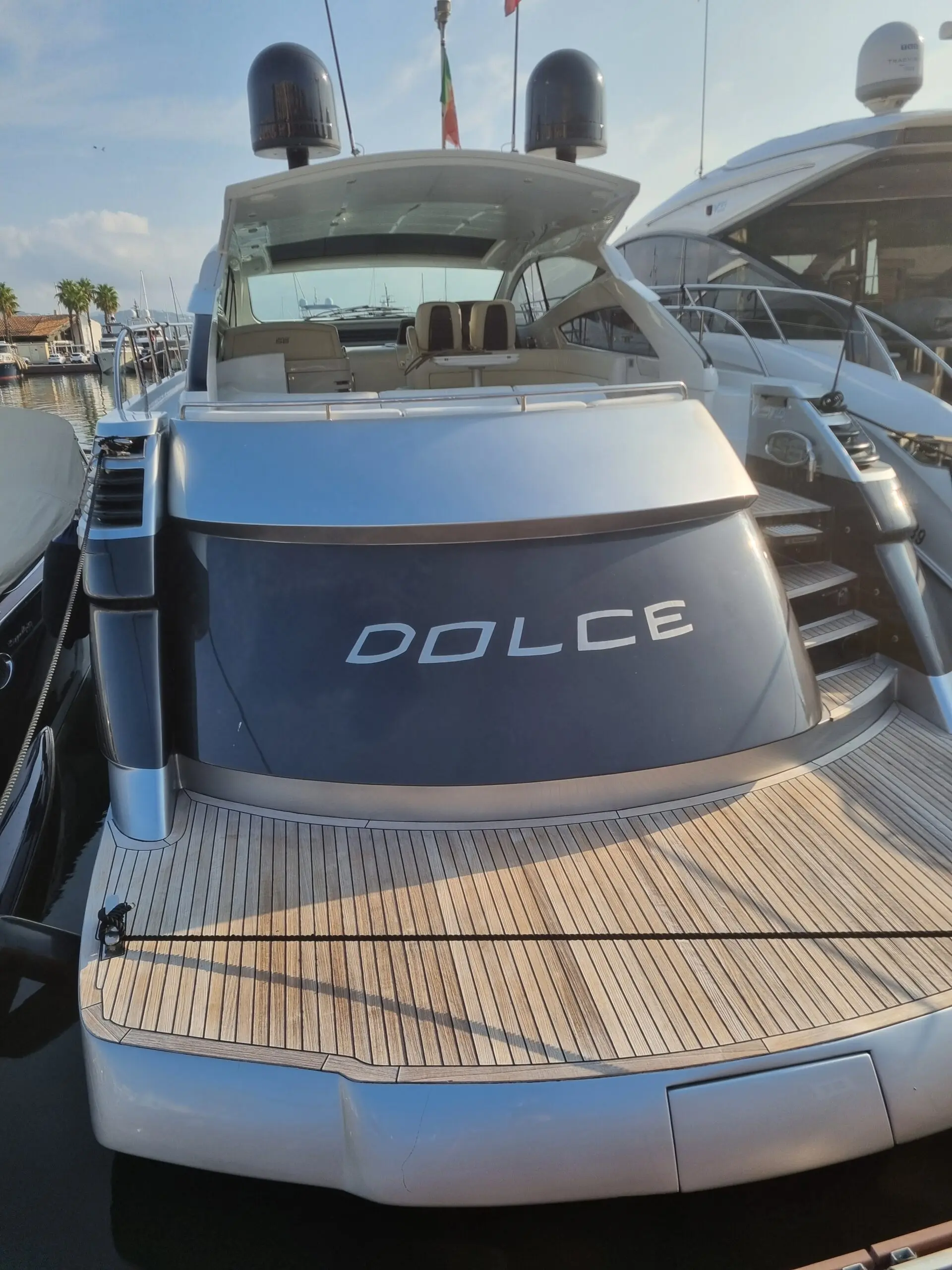 Pershing 56 HT — Vue arrière d’un yacht à quai, avec cockpit, plage arrière et passerelle.