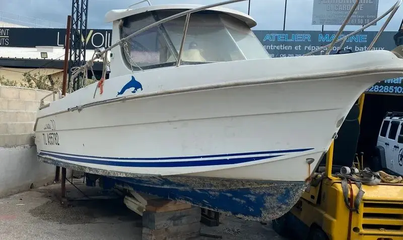 Arvor 20 — Bateau blanc à cabine, posé à terre dans un chantier nautique.