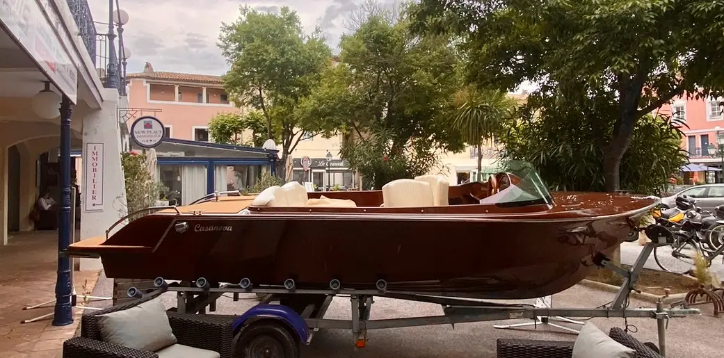 Kruger 23 Casanova — Bateau à moteur brun présenté sur une remorque, vu de profil dans une rue.