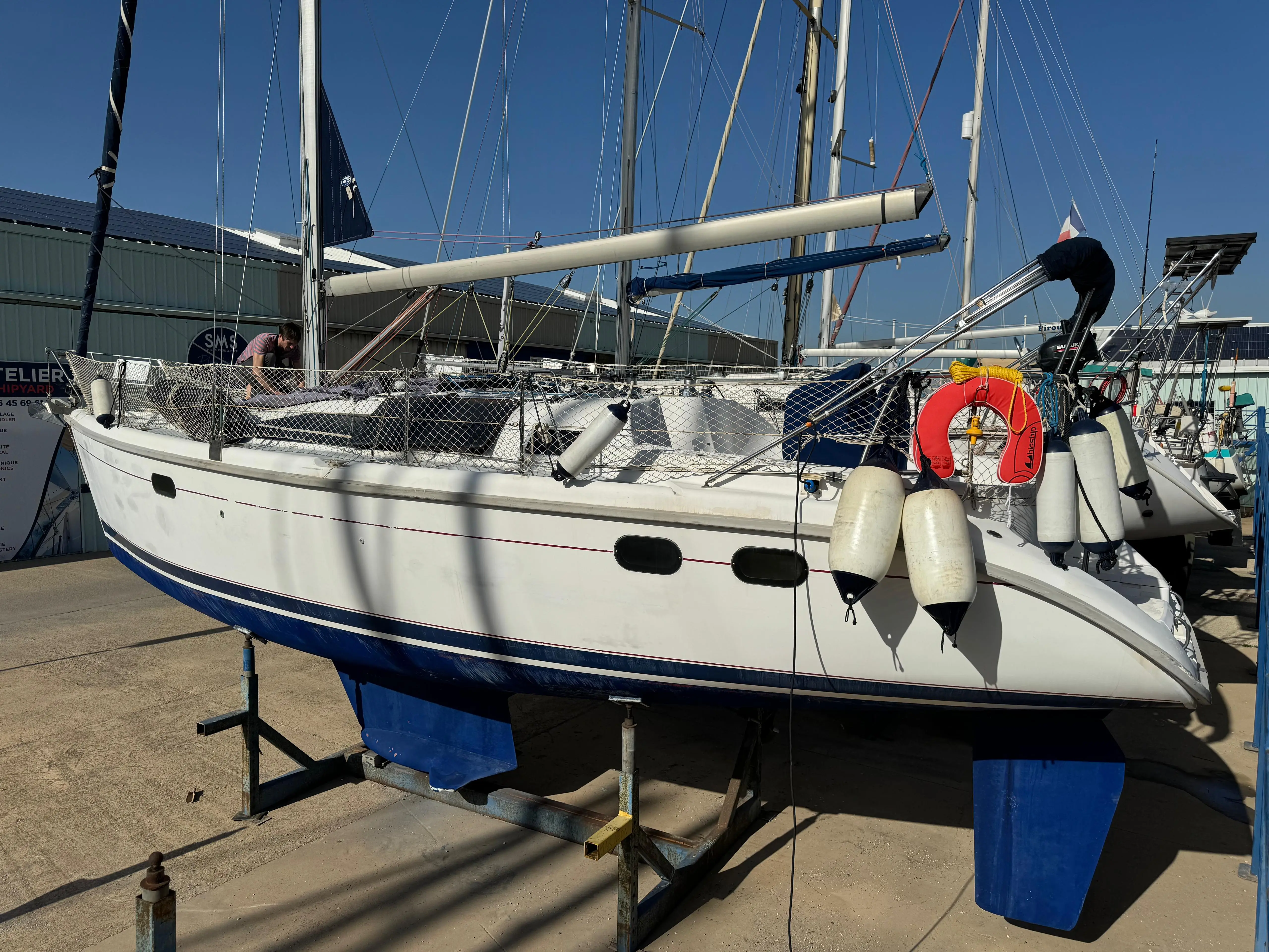 Hunter 376 — Voilier blanc vu de trois quarts tribord, posé sur bers dans un chantier naval.