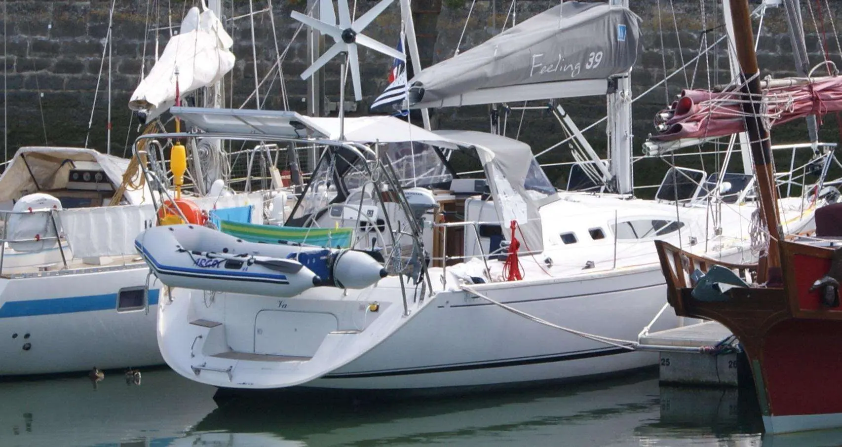 Kirie Feeling 39 — Voilier blanc amarré au port, vu de trois quarts arrière parmi d'autres bateaux.