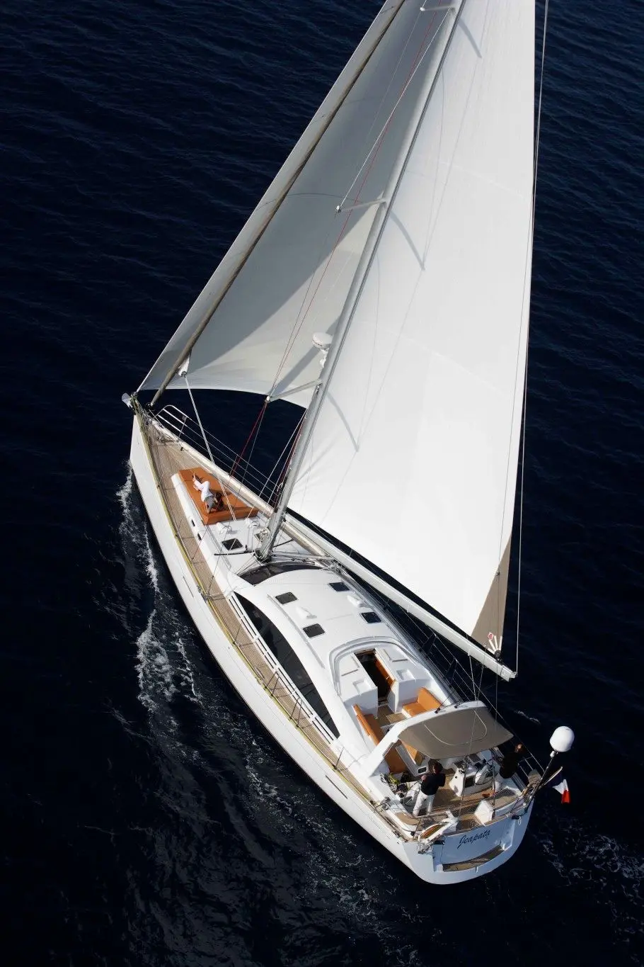 Wauquiez Pilot Saloon 55 — Voilier blanc sous voiles, photographié en vue aérienne sur une mer sombre.