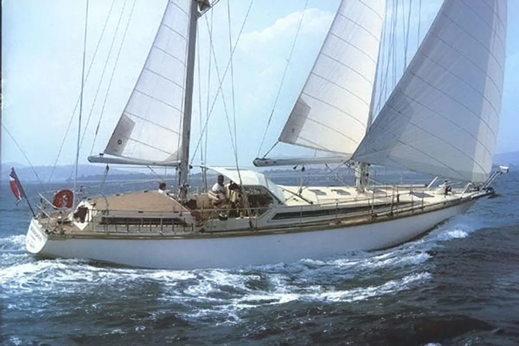 Amel Mango — Voilier monocoque naviguant sous voiles, vu de profil sur une mer agitée.
