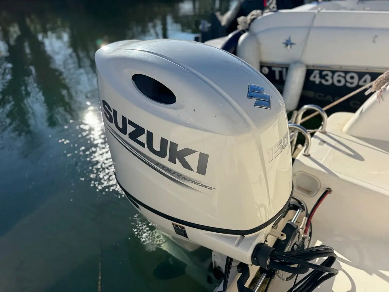 Kelt Azura 575 — Vue rapprochée d'un moteur hors-bord Suzuki monté à l'arrière d'un bateau.
