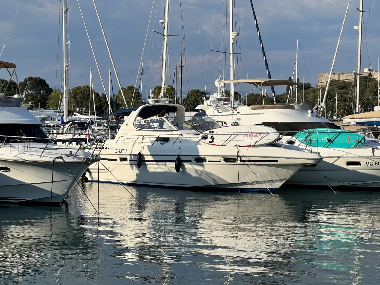 Sealine Ambassador 380 — Vedette blanche amarrée dans un port, entourée d'autres bateaux.