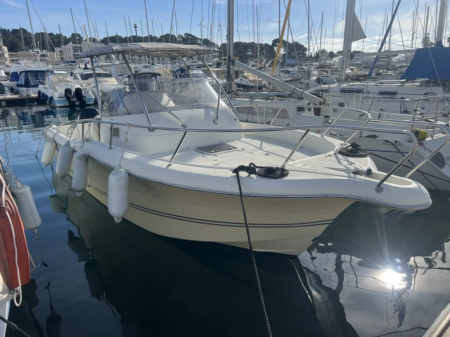 White Shark 268 — Bateau à moteur blanc amarré dans une marina, vu de trois quarts avant.