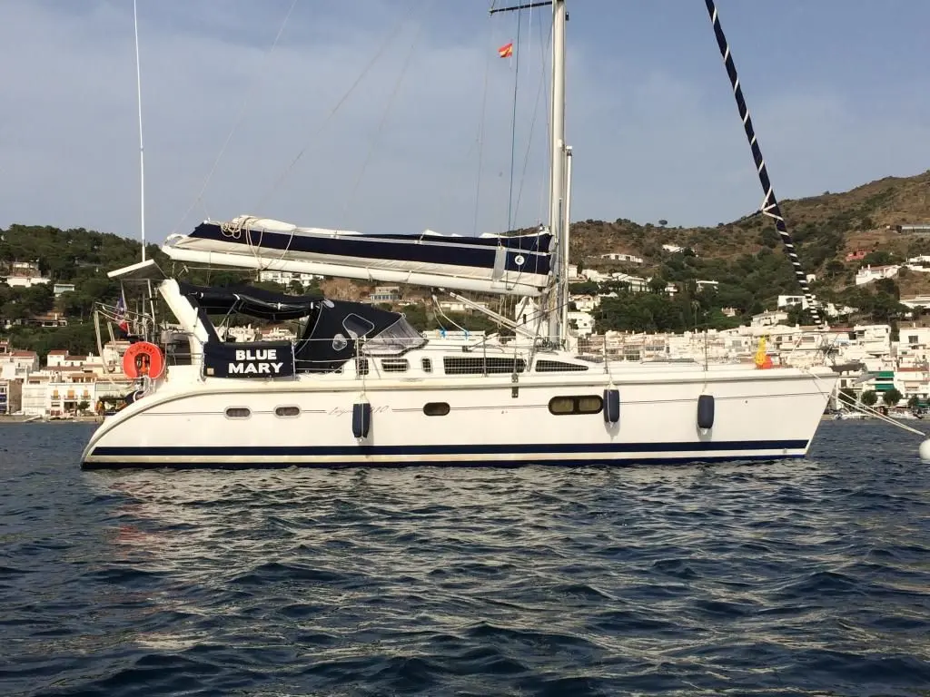 Hunter 410 — Voilier blanc vu de profil dans une baie, avec ses voiles ferlées.