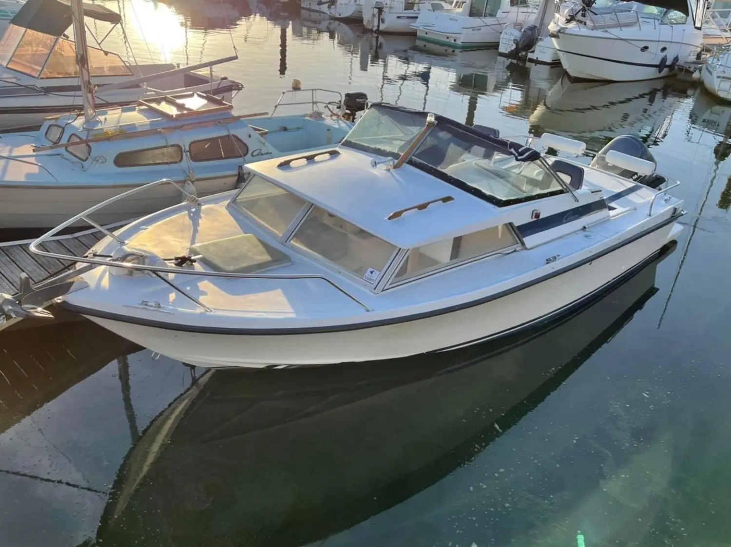 Yachting France Arcoa 680 — Bateau à moteur blanc amarré dans une marina, photographié en vue trois quarts.