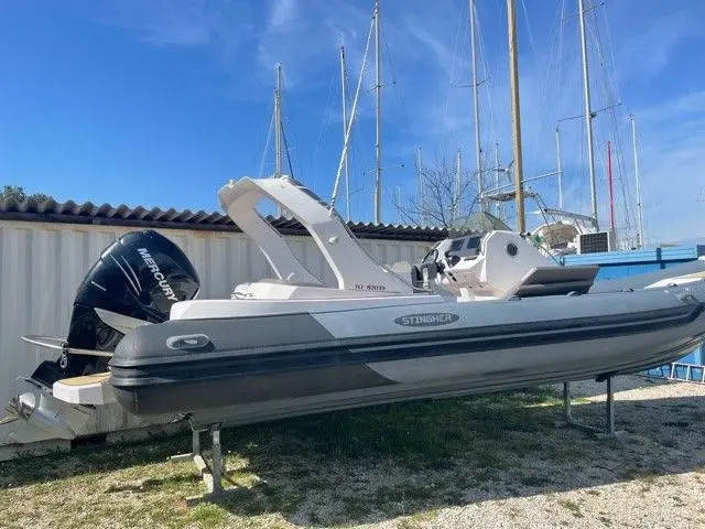 Italboats STINGHER 30 GT — Bateau semi-rigide gris présenté sur remorque, vu de profil dans un port à sec.