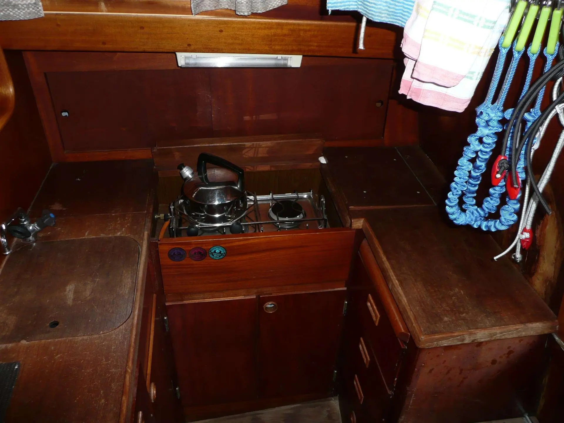 Vindo Marin Vindo 50 — Cuisine de bateau en bois avec réchaud, évier et rangements.