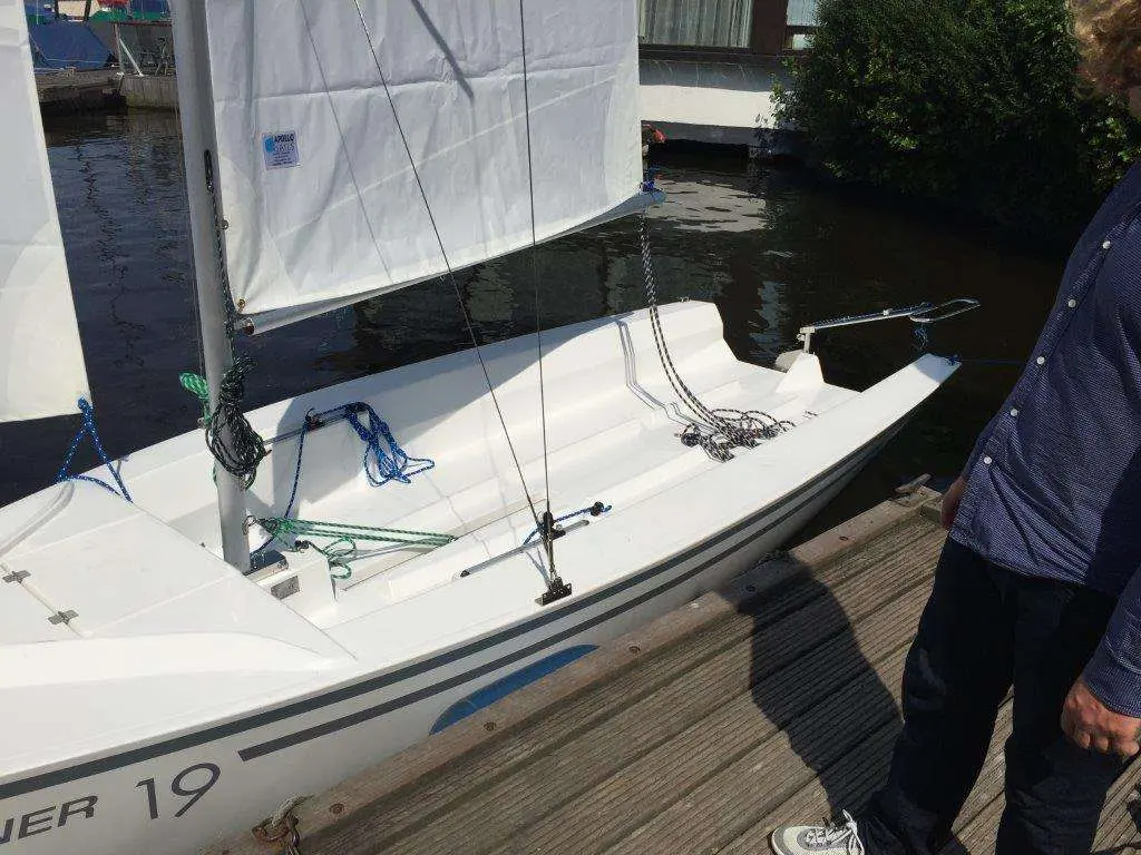 Mariner Yachts 19 — Vue partielle d’un petit voilier blanc amarré à un ponton.