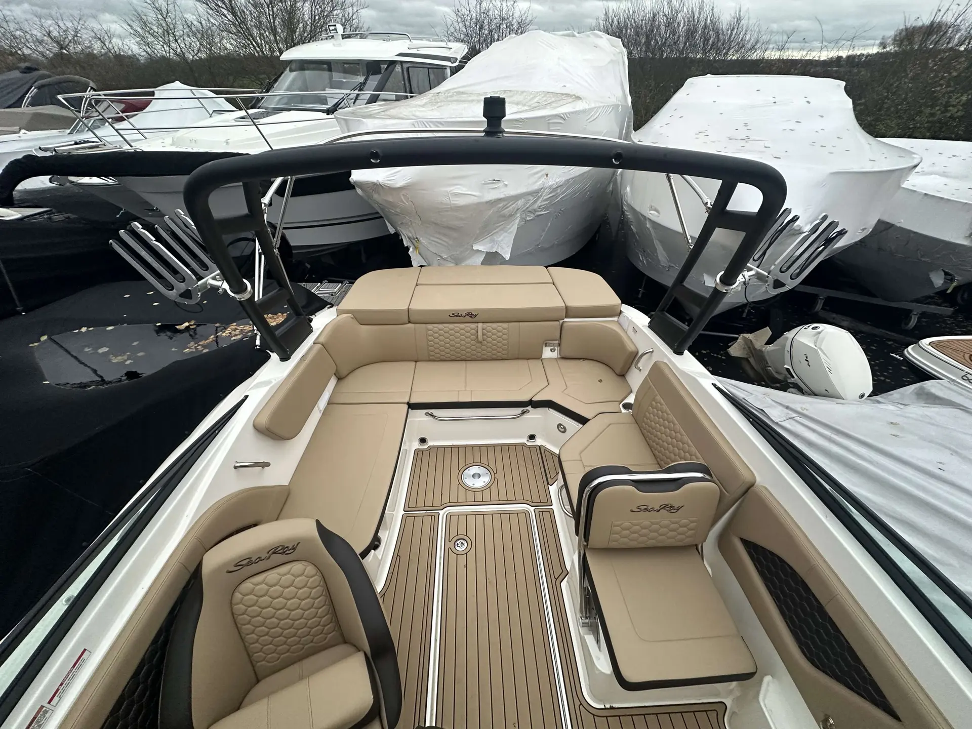 Sea Ray 230 SSE — Vue du cockpit avant avec banquettes, sièges et plancher aménagé.
