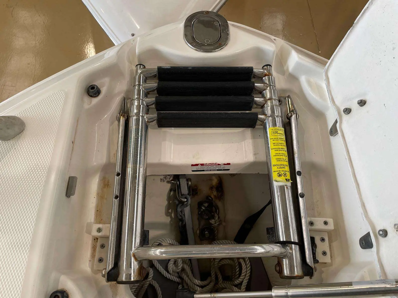 Chaparral Sunesta 244 — Vue rapprochée d'une échelle et d'un compartiment ouvert à l'arrière du bateau.