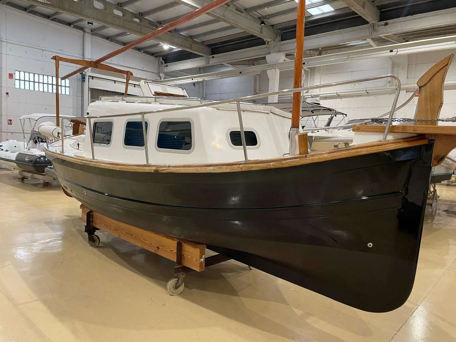 Tiburon 37 Cabinado — Bateau à cabine photographié de trois quarts dans un hangar intérieur.