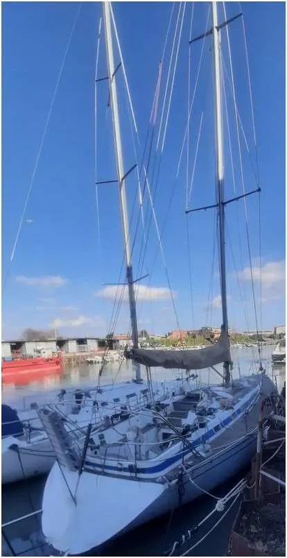 Grand Soleil 45 — Voilier blanc amarré dans un port, vu de l’avant entre d’autres bateaux.