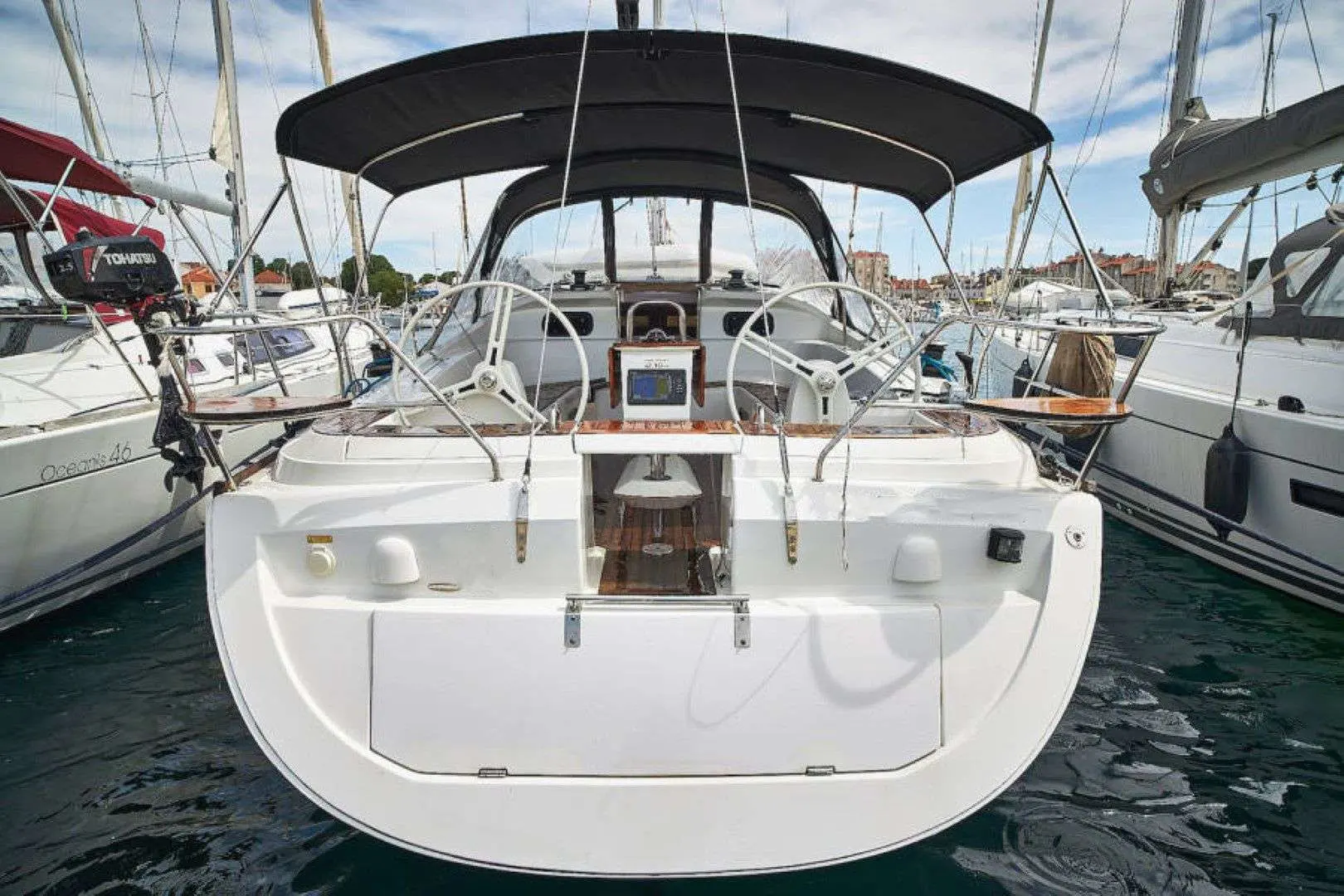 Elan Impression 444 — Vue arrière du cockpit et de la plage de bain d’un voilier amarré au port.