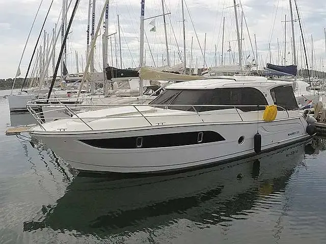 Marex 375 — Bateau à moteur blanc vu de trois quarts dans un port de plaisance.