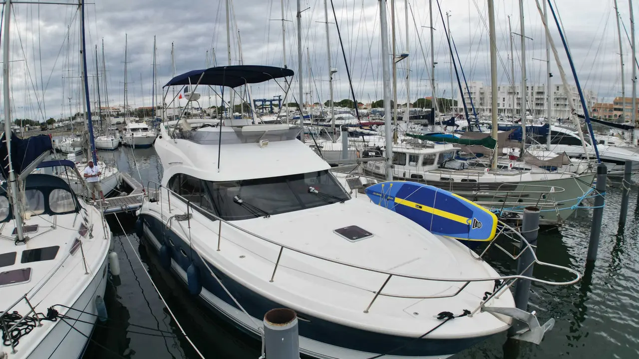 Beneteau Antares 42 — Bateau à moteur amarré dans une marina, vu de trois quarts avant.