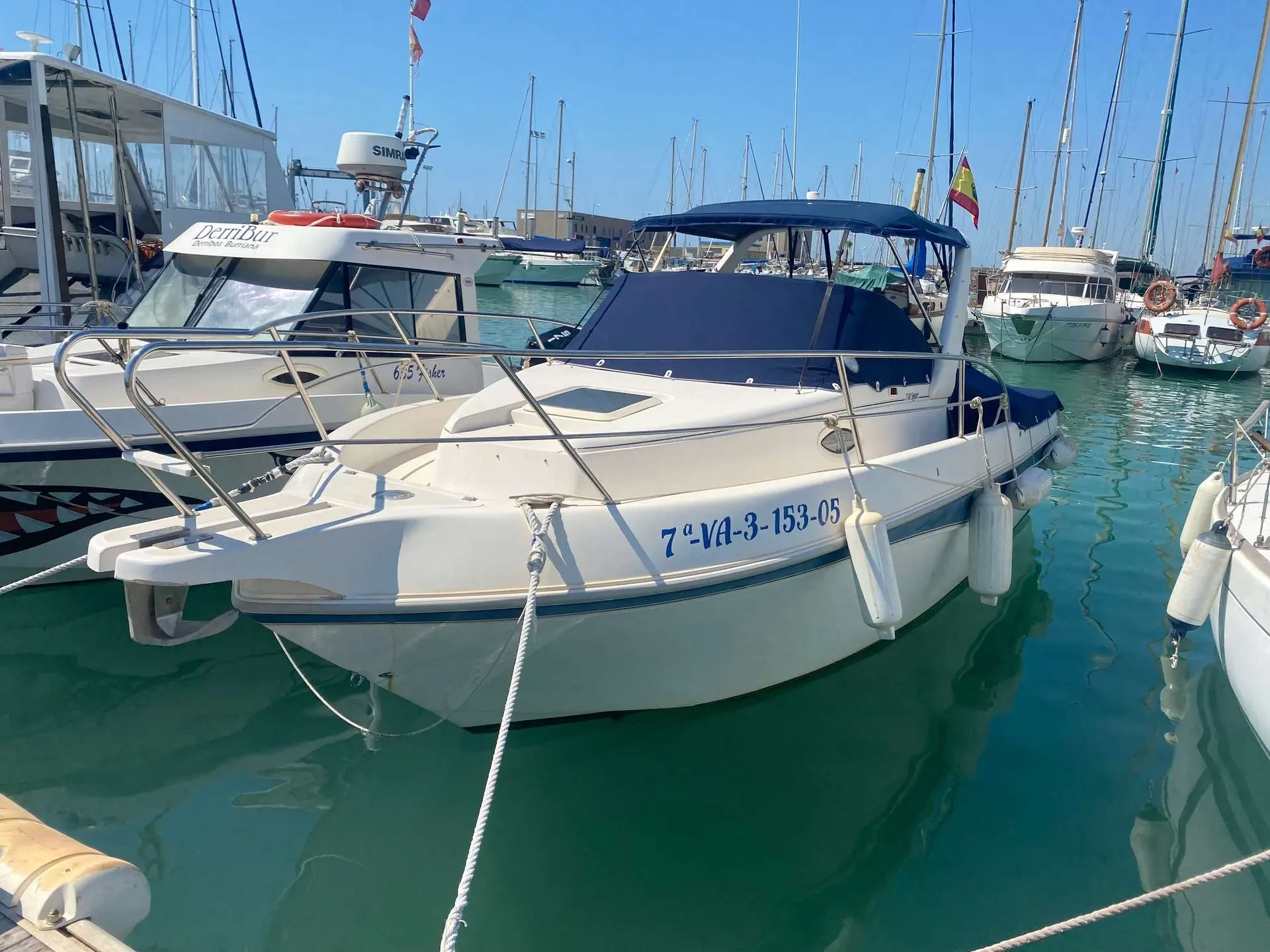 Faeton 730 Moraga — Bateau à moteur blanc amarré dans une marina, vu de trois quarts avant.