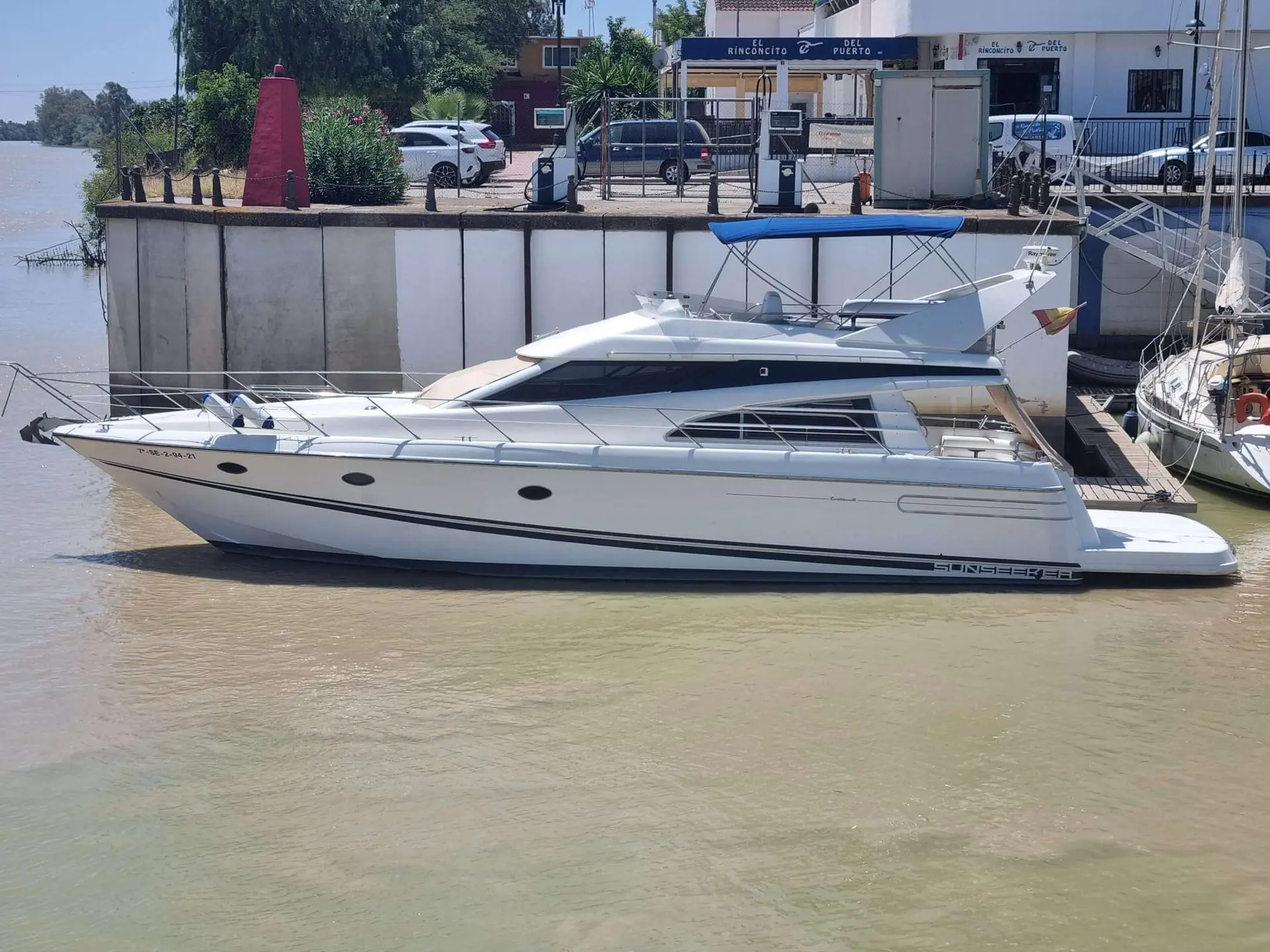 Sunseeker Predator 52 — Bateau à moteur blanc photographié de profil dans un port fluvial.