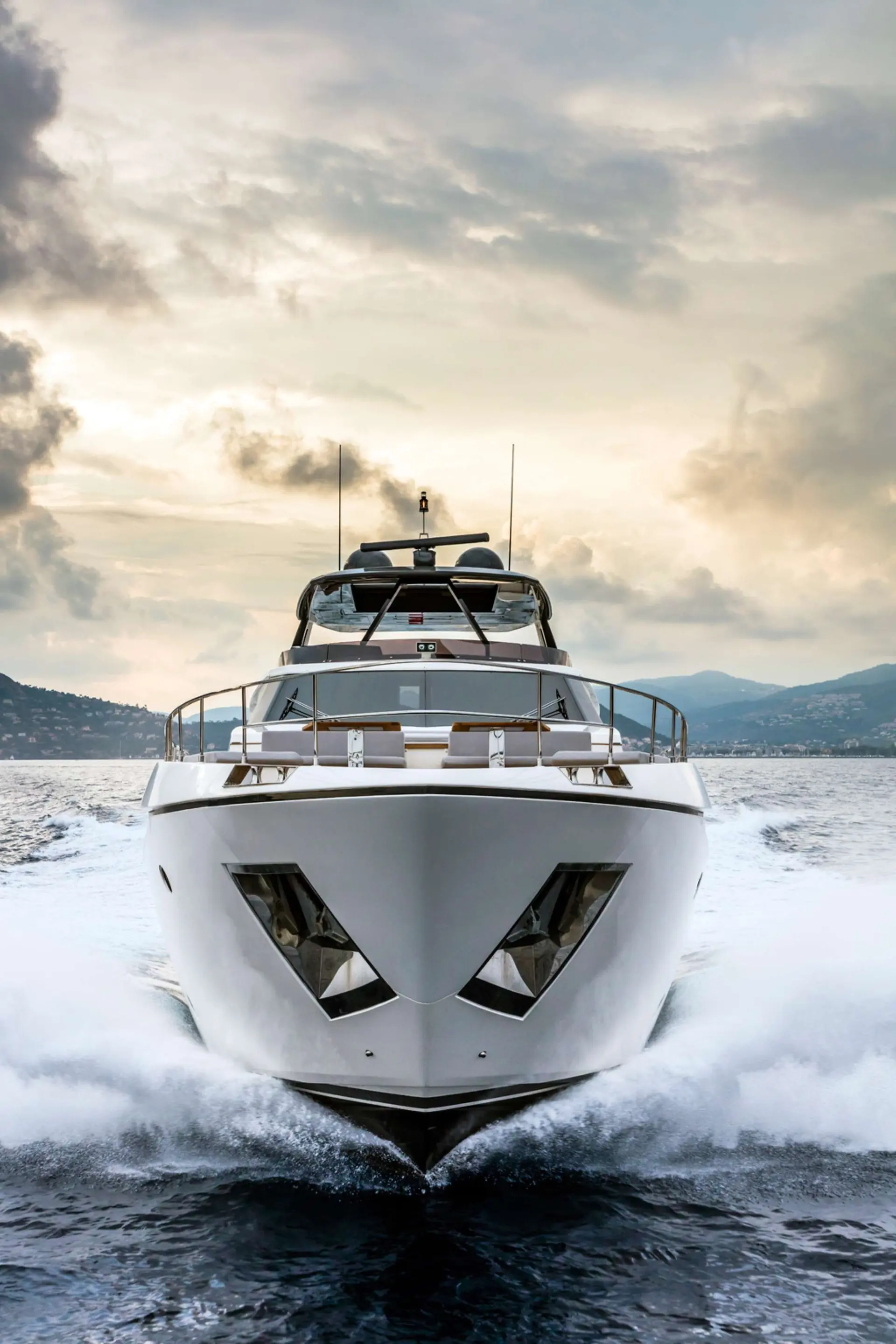 Ferretti 920 — Bateau à moteur blanc naviguant de face sur un lac, entouré d’écume.