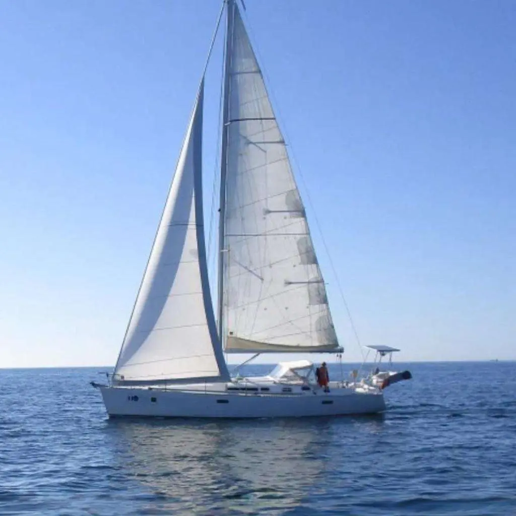 Jeanneau Sun Fast 42 — Voilier monocoque vu de profil, toutes voiles hissées sur une mer calme.
