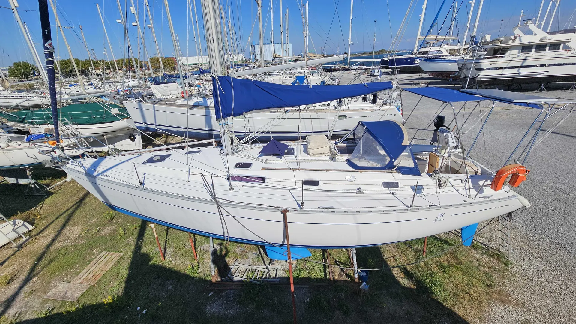 Dufour 38 — Voilier blanc vu de profil sur bers, dans un port à sec.