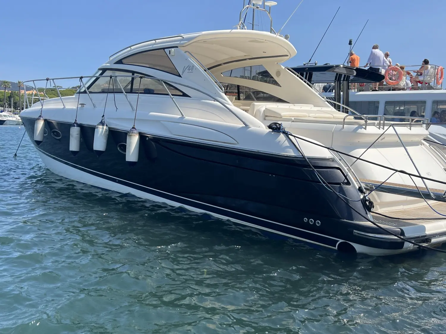 Princess V48 — Bateau à moteur amarré, photographié de trois quarts bâbord dans une marina.