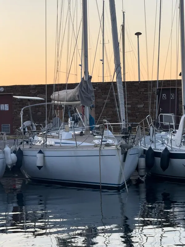 Grand Soleil 39 — Voilier blanc amarré dans un port, entouré d’autres bateaux.