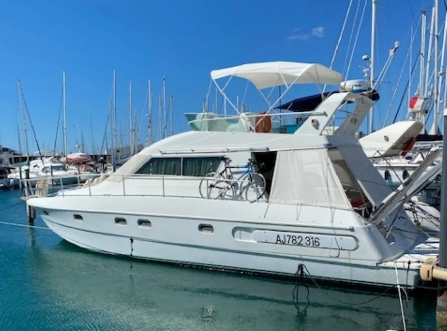 Yarding 42 — Vue de profil d’un bateau à moteur blanc amarré dans une marina.
