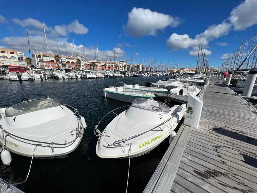 Conero 480 — Deux bateaux à moteur amarrés dans un port, avec d'autres embarcations en arrière-plan.