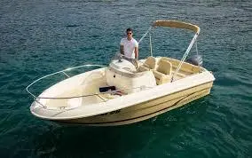 Jeanneau Cap Camarat 555 — Bateau à moteur vu de trois quarts sur l’eau, avec une personne à bord.
