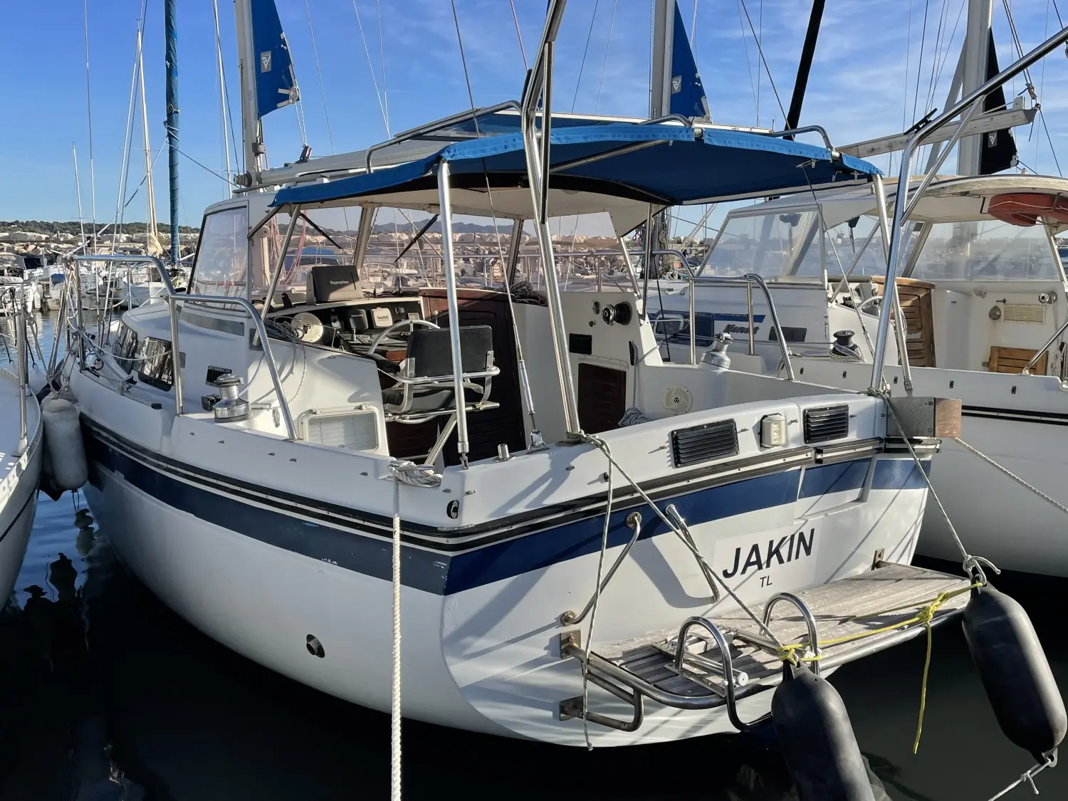 Kirie Fifty 33 — Voilier blanc amarré dans un port, photographié de trois quarts arrière.