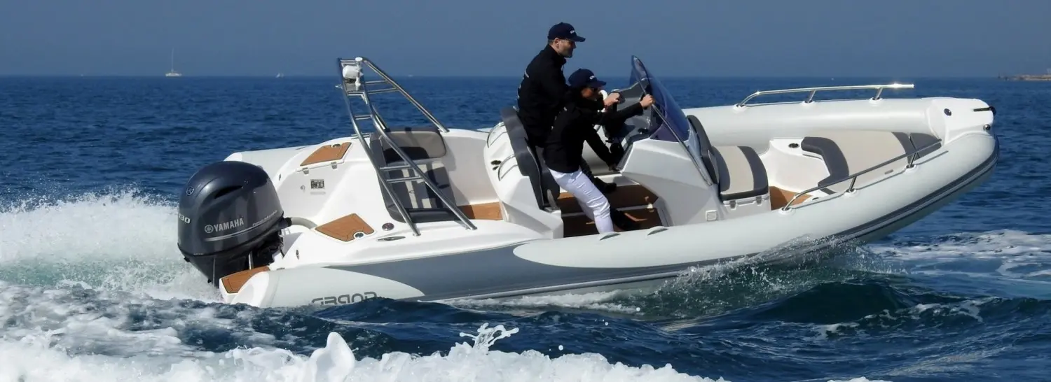 Grand Golden Line G580 — Bateau pneumatique à moteur naviguant en mer avec deux personnes à bord.