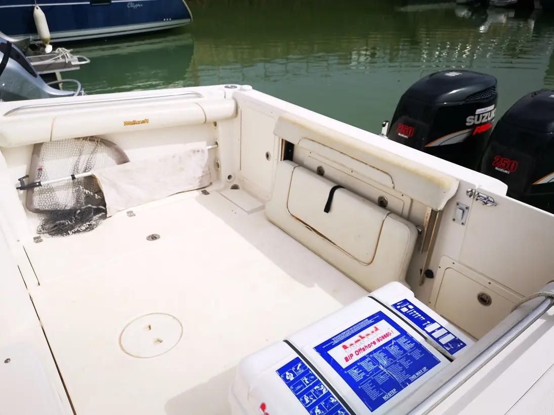 Wellcraft Coastal 270 — Vue du cockpit arrière avec deux moteurs hors-bord et équipements de pêche.