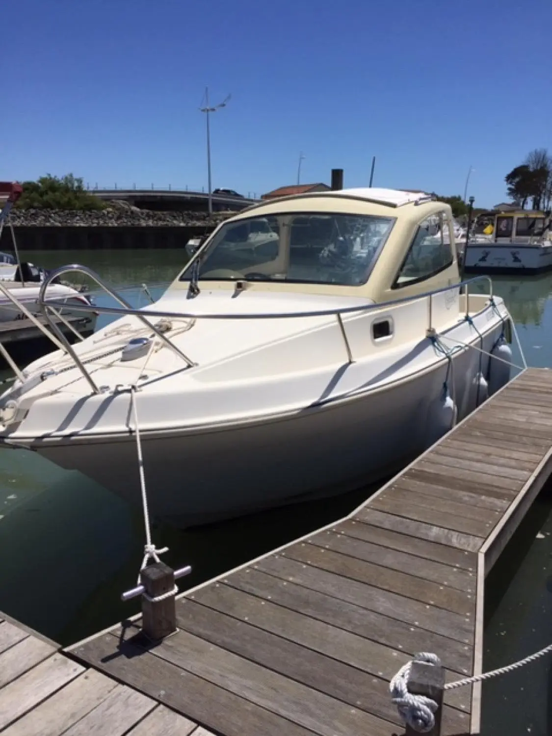 Guymarine Spacio 6 — Bateau à cabine amarré dans un port, vu de trois quarts avant.