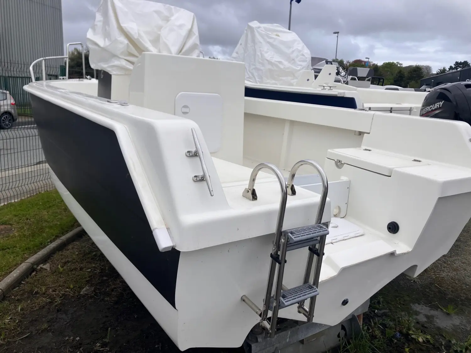 Acroplast Albacore — Vue arrière d’un bateau blanc et bleu équipé d’une échelle de baignade.